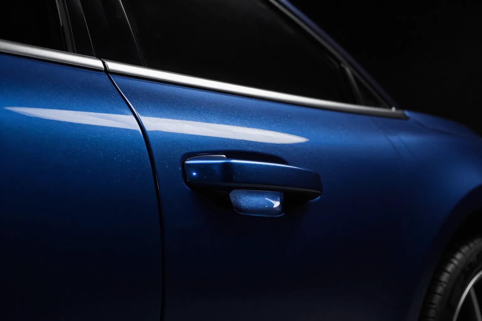 The same door panel after correction, with a sharp mirror-gloss reflection
